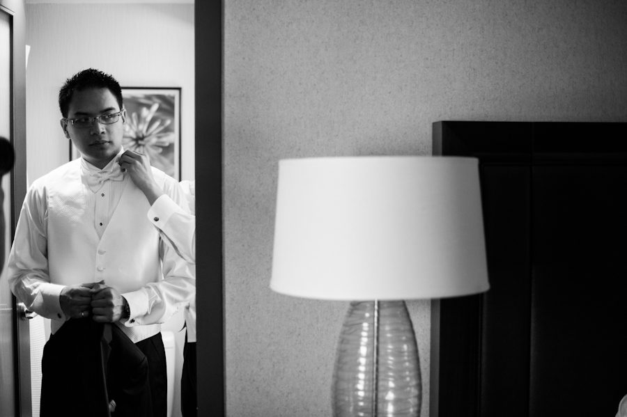 Groom prepares for his wedding day at the Sheraton in Montreal, QC. Captured by destination wedding photographer Ben Lau.