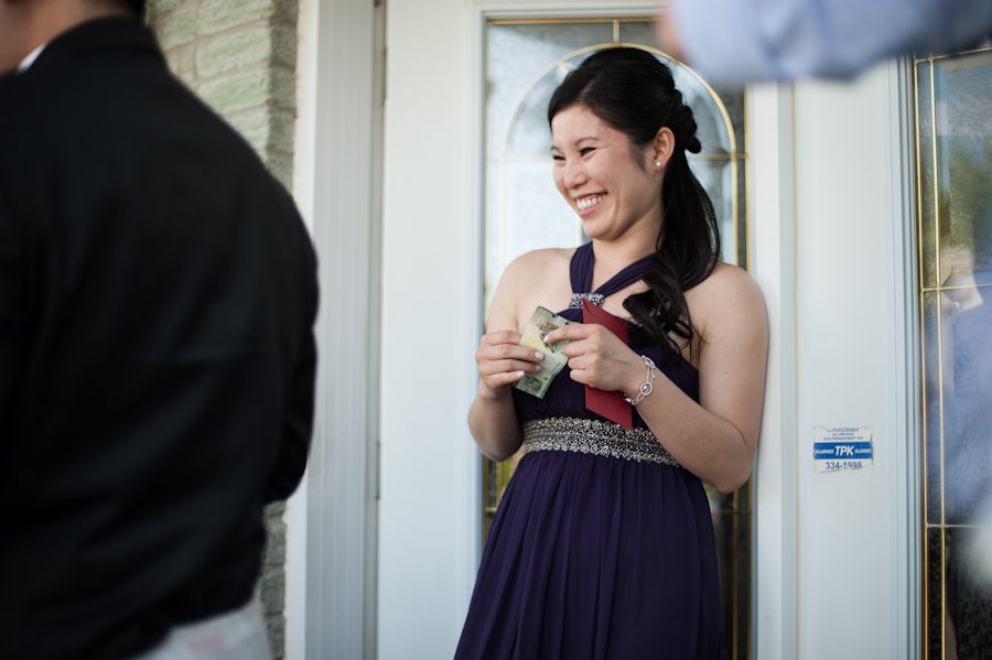 Bridesmaid laughs during wedding door games in Montreal, QC. Captured by destination wedding photographer Ben Lau.