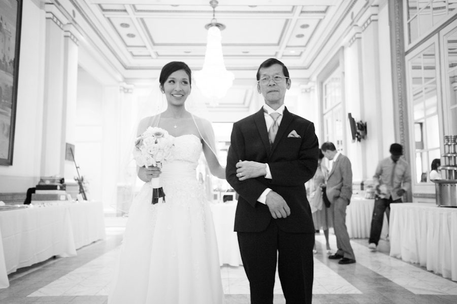 Bride with her father get ready for her ceremony entrance at Le Windsor in Montreal, QC. Captured by destination wedding photographer Ben Lau.