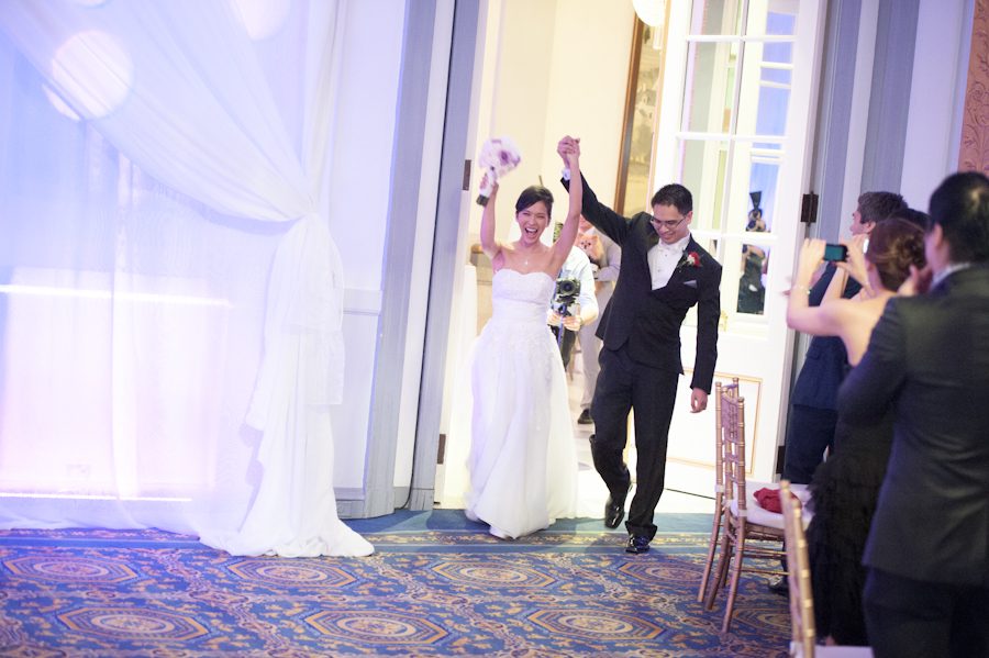 Bride and groom's grand entrance at their wedding reception at Le Windsor in Montreal, QC. Captured by destination wedding photographer Ben Lau.
