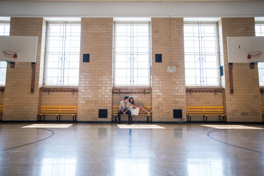 Christina and Nick pose inside an elementary school gymnasium for the engagement session with New York City Wedding photographer Ben Lau.