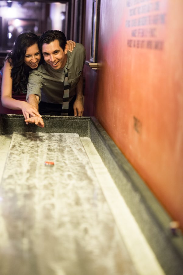 Nick and Christina play shuffleboard their engagement session in Williamsburg with New York City Wedding Photographer Ben Lau.