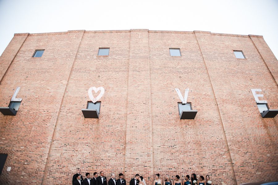 Bridal party pose in Federal Hill near M&T Bank Raven Stadium in Baltimore, MD. Captured by awesome NJ wedding photographer Ben Lau.