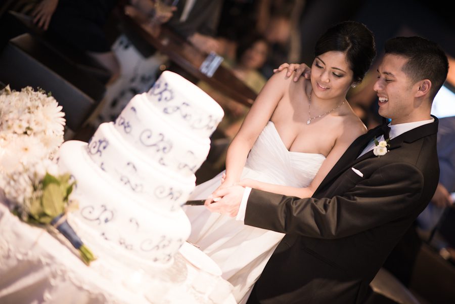 Cake cutting during wedding at Ravens Stadium in Baltimore, MD. Captured by awesome Ben Lau Photography.
