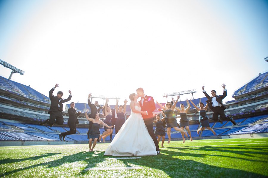 Bridal party pose during a wedding at Raven Stadium in Baltimore, MD. Captured by awesome Ben Lau Photography.