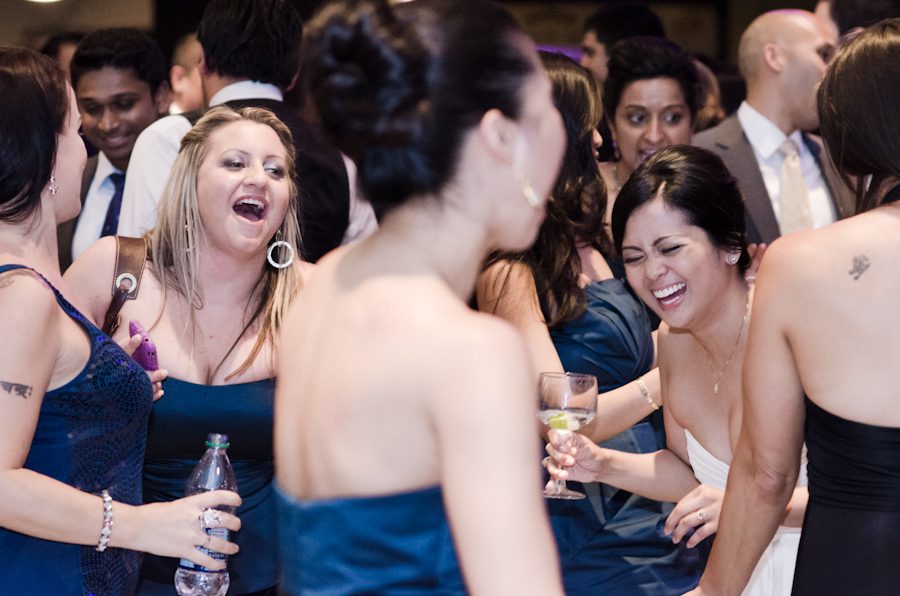 Bride laughs during her wedding reception at Raven Stadium in Baltimore, MD. Captured by awesome Ben Lau Photography.