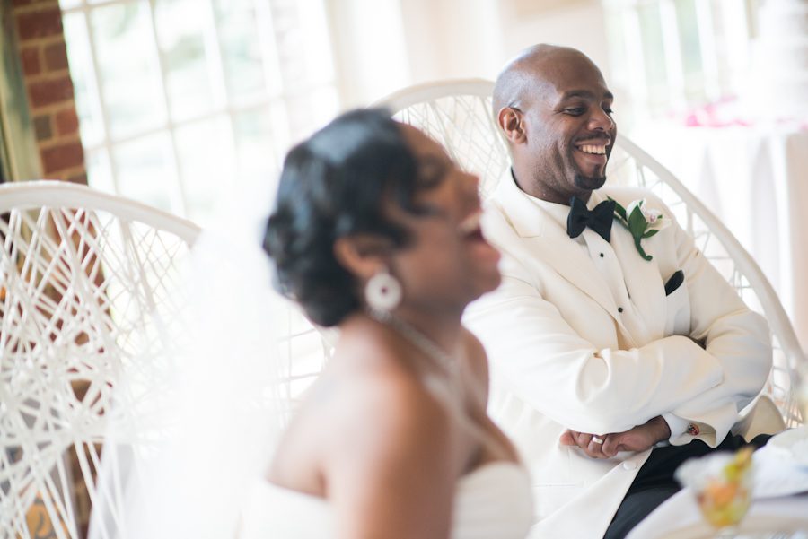 Sandra and Jamal laugh during speeches during their wedding at the Coral House in Baldwin, NY. Captured by awesome NJ wedding photographer Ben Lau.