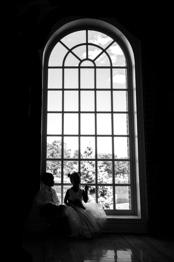 Children play by the window during a wedding reception at the Coral House in Baldwin, NY. Captured by awesome NJ wedding photographer Ben Lau.