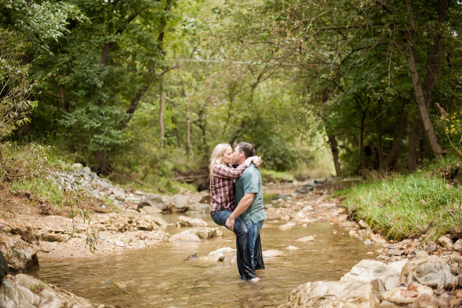 Fran and Joe share a kiss in the creek during their engagement session at the Loch Raven Resevoir in Baltimore, MD with Ben Lau Photography.