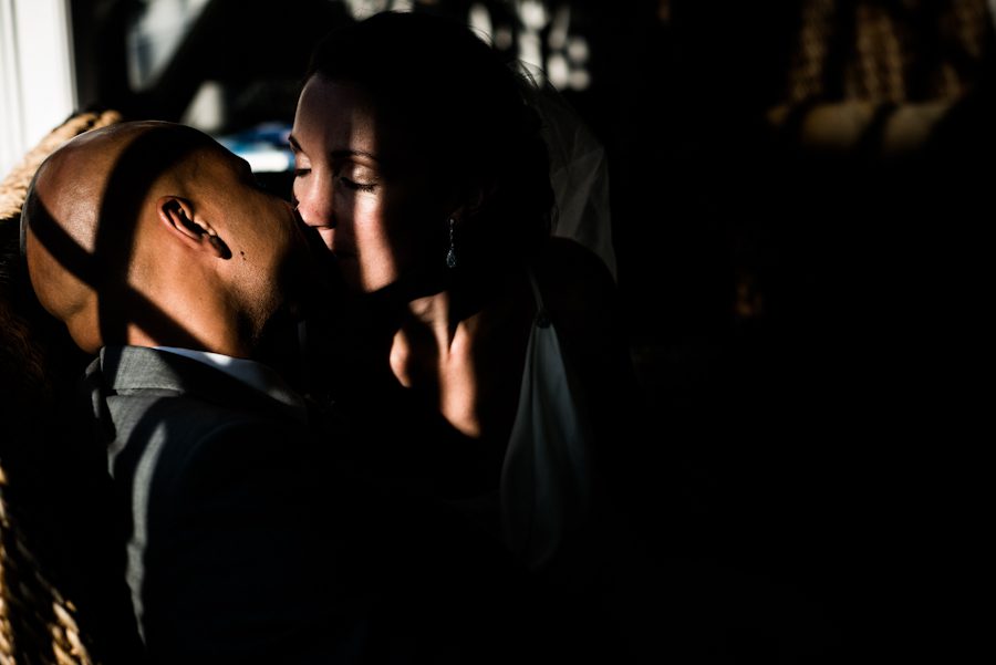 Bride and groom share a kiss on their wedding day at the Ram's Head Inn on Shelter Island. Captured by New Jersey Wedding Photographer Ben Lau.