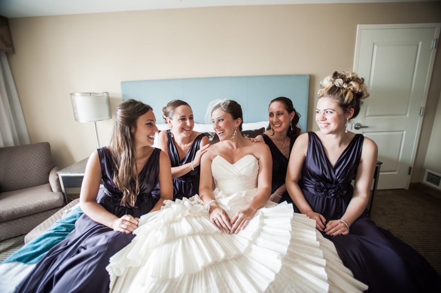 Bride with her bridesmaids on her wedding day at the Heldrich Hotel in New Brunswick, NJ. Captured by awesome northern NJ wedding photographer Ben Lau.