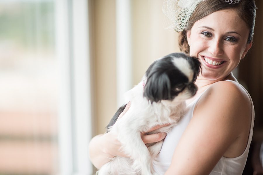Bride poses with her dog on her wedding day at the Heldrich Hotel in New Brunswick, NJ. Captured by awesome northern NJ wedding photographer Ben Lau.