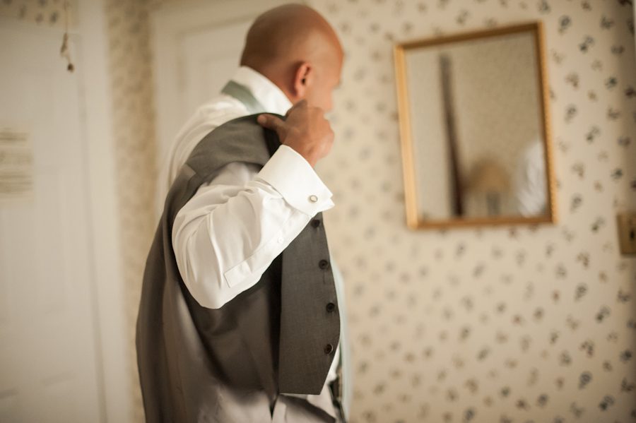 Groom preps for his wedding day at Ram's Head Inn on Shelter Island, NY. Captured by Northern NJ wedding photographer Ben Lau.