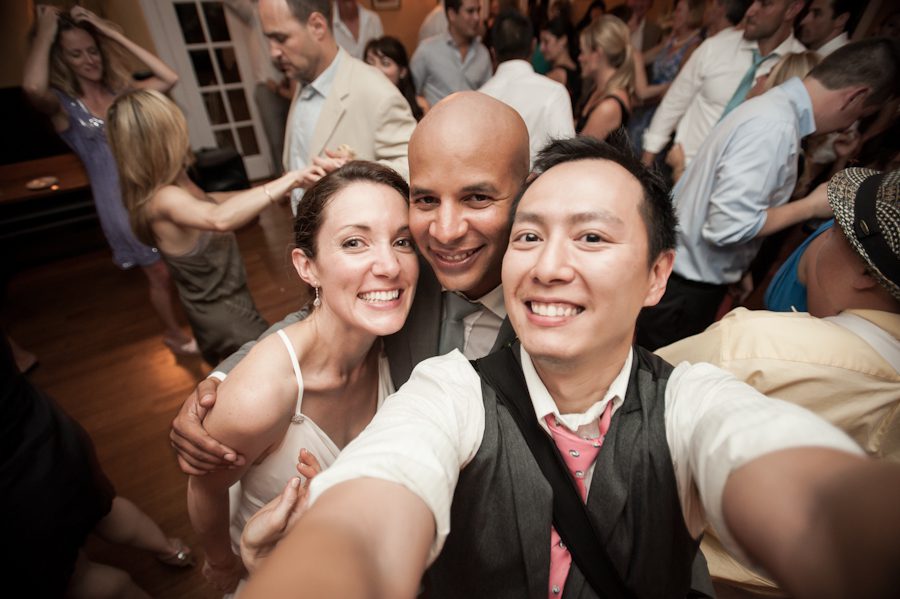 Katie and Jason poses for a photo with Ben Lau during their wedding reception at Ram's Head Inn on Shelter Island, NY. Captured by Northern NJ wedding photographer Ben Lau.