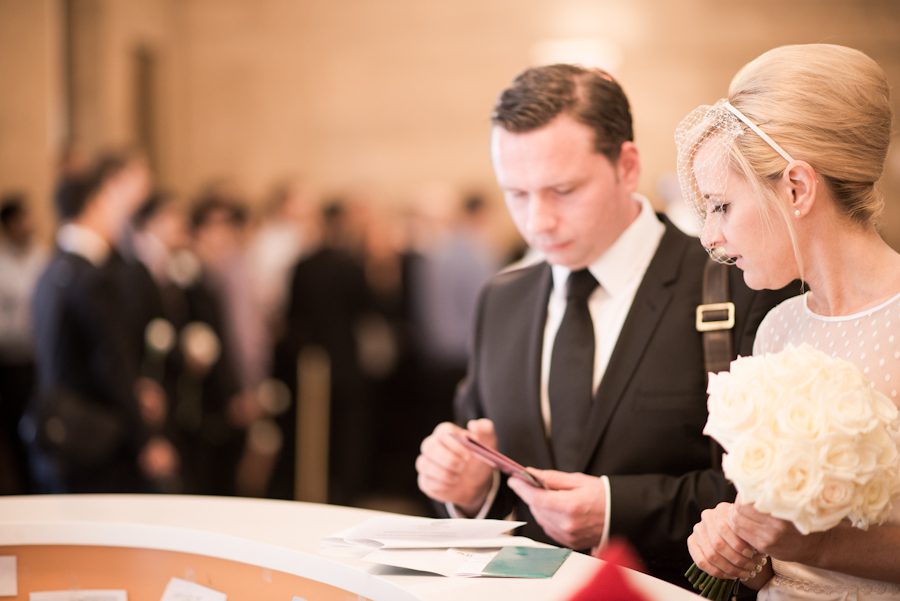 Bride and groom prepare their paperwork for New York City Hall wedding. Captured by northern NJ wedding photographer Ben Lau.