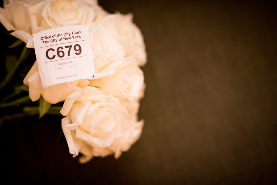Bride and groom's flowers and ticket number before their New York City Hall wedding. Captured by northern NJ wedding photographer Ben Lau.