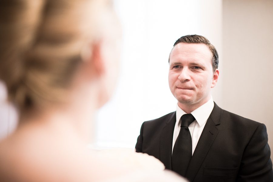 Groom exchanges vows during a New York City Hall wedding. Captured by northern NJ wedding photographer Ben Lau.