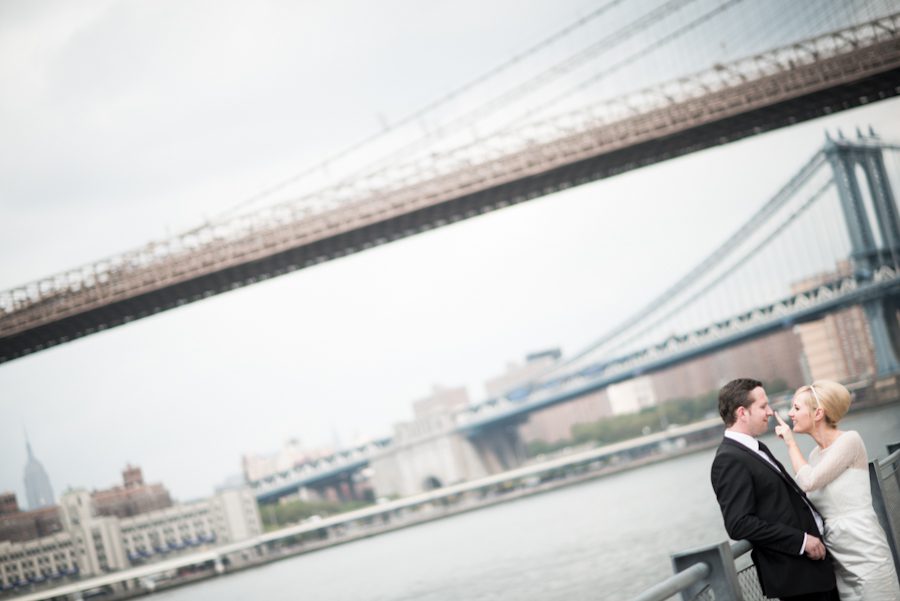 Bride and groom pose for portraits in Brooklyn Bridge Park after their New York City Hall wedding. Captured by northern NJ wedding photographer Ben Lau.
