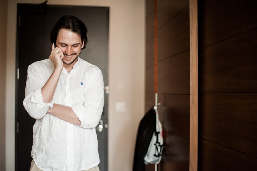 Groom talks on the phone on the morning of his wedding at the Eventi hotel in New York City. Captured by northern NJ wedding photographer Ben Lau.