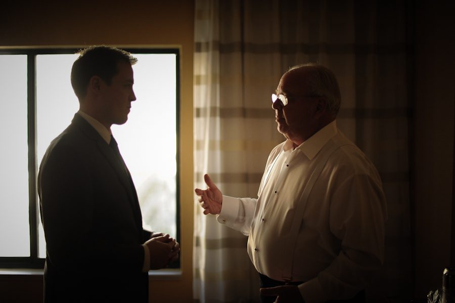 Groom gets a few words of wisdom from his father on his wedding day at the Liberty House in Jersey City, NJ. Captured by northern NJ wedding photographer Ben Lau.