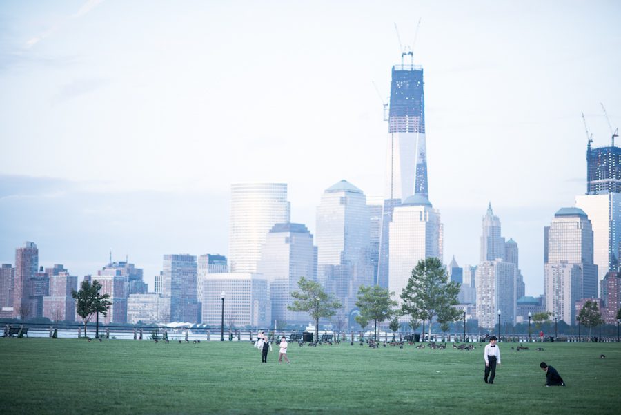 View of the Manhattan skyline during an outdoor wedding ceremony at the Liberty House in Jersey City, NJ. Captured by northern NJ wedding photographer Ben Lau.