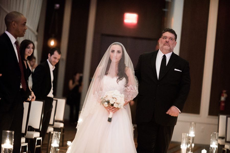 Wedding procession with bride and her father at the Eventi Hotel in New York City. Captured by NYC wedding photographer Ben Lau.