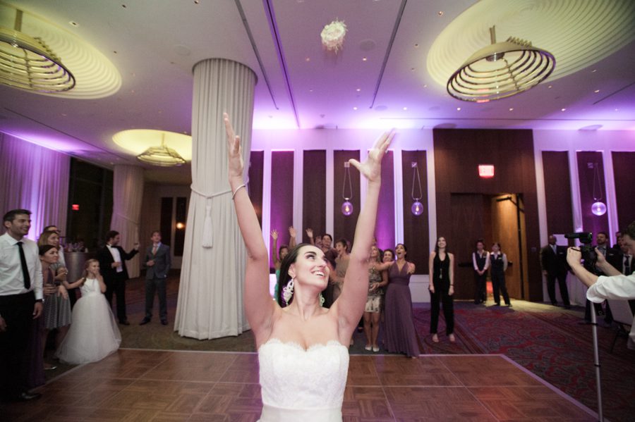 Bouquet toss during a wedding reception at the Eventi Hotel in New York City. Captured by NYC wedding photographer Ben Lau