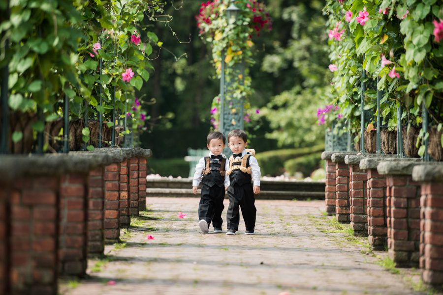 Twin ring boys walk down the aisle at Sarah and Ed's wedding at The Manor in West Orange, NJ. Captured by northern NJ wedding photographer Ben Lau.