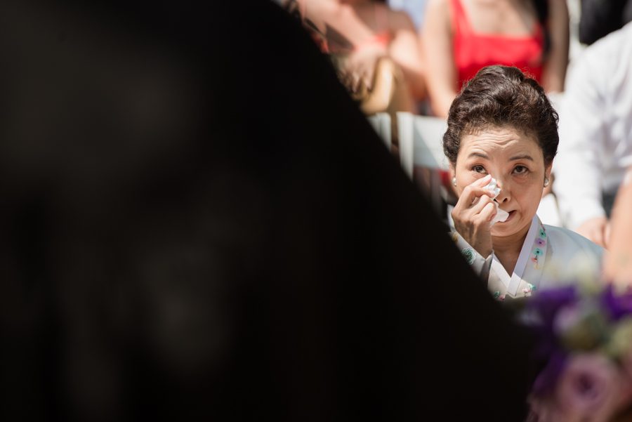 Bride's mother cries during Sarah and Ed's wedding ceremony at The Manor in West Orange, NJ. Captured by northern NJ wedding photographer Ben Lau.