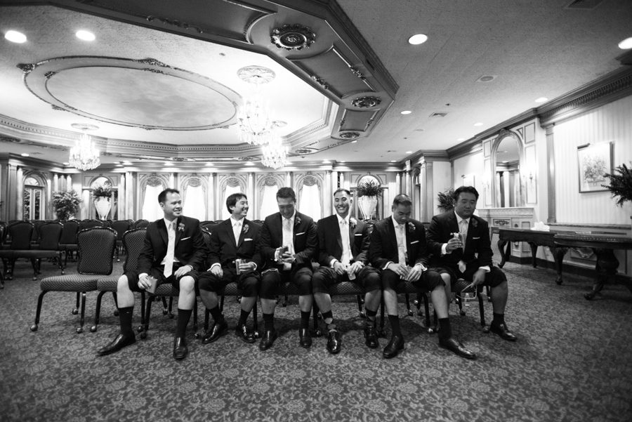Groomsmen pose together after an outdoor wedding ceremony at The Manor in West Orange, NJ. Captured by northern NJ wedding photographer Ben Lau.