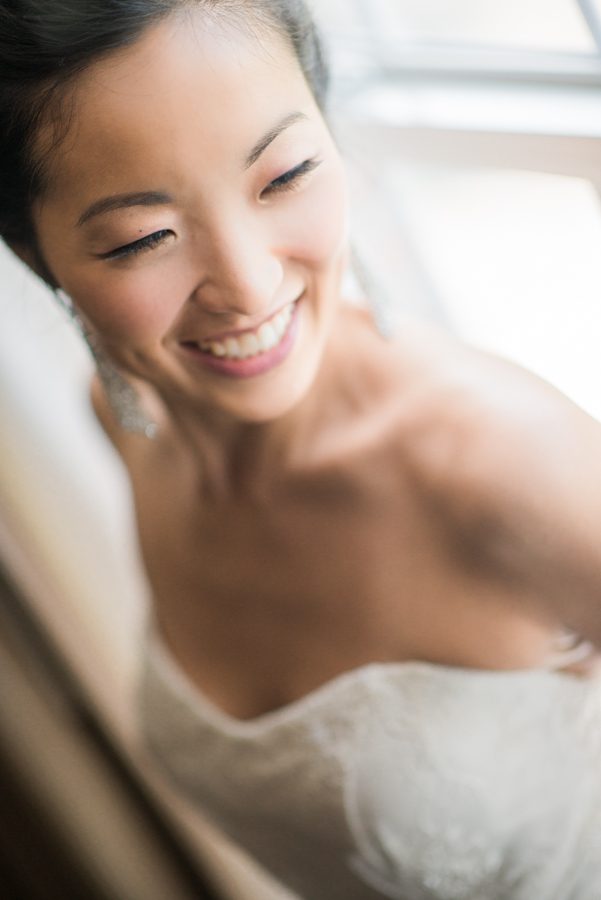 Bride Sarah poses for her portraits on the morning of her wedding at The Manor in West Orange, NJ. Captured by northern NJ wedding photographer Ben Lau.