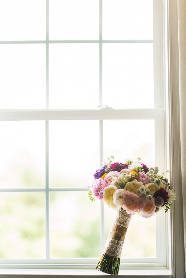 Bride's flowers sit on a window on the morning of her wedding at The Manor in West Orange, NJ. Captured by northern NJ wedding photographer Ben Lau.