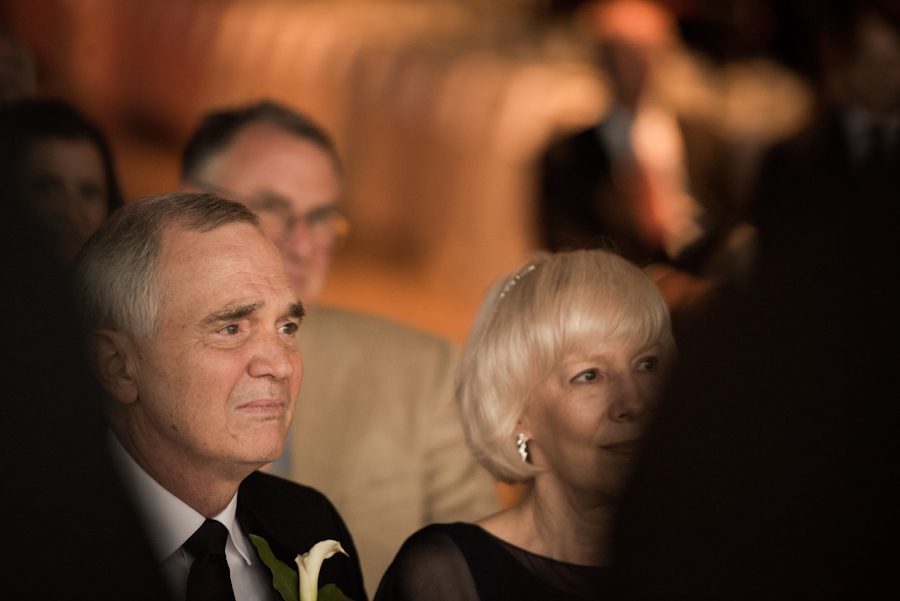 Father of the groom cries during a wedding ceremony at the Baltimore Museum of Industry in Baltimore, MD. Captured by northern NJ wedding photographer Ben Lau.