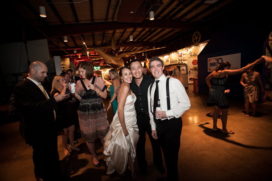 Ben Lau poses with a couple at a wedding reception at the Baltimore Museum of Industry in Baltimore, MD. Captured by northern NJ wedding photographer Ben Lau.