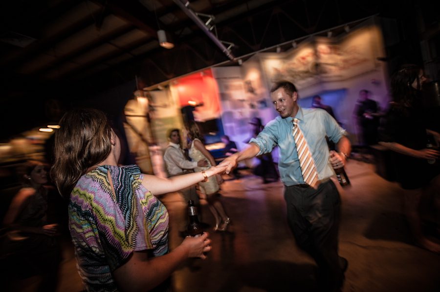 Guests dance at a wedding reception at the Baltimore Museum of Industry in Baltimore, MD. Captured by northern NJ wedding photographer Ben Lau.