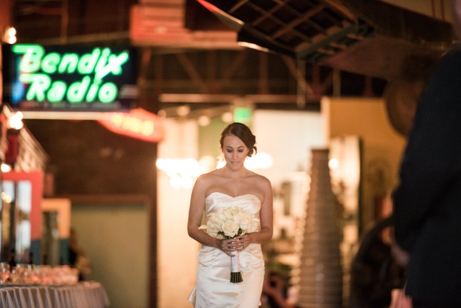 Bride walks down the aisle during her wedding ceremony at the Baltimore Museum of Industry in Baltimore, MD. Captured by northern NJ wedding photographer Ben Lau.