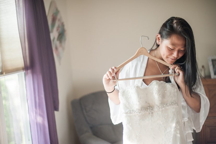 Bride inspects her dress before her wedding at the Neshanic Valley Golf Course in Neshanic Station, NJ. Captured by northern NJ wedding photographer Ben Lau.