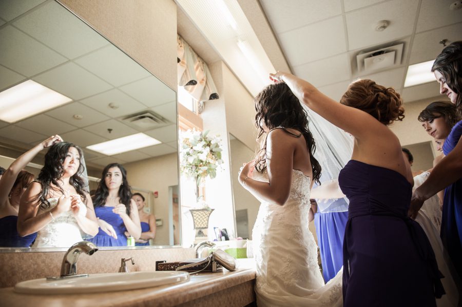 Bride and her bridesmaids getting ready before a wedding at the Neshanic Valley Golf Course in Neshanic Station, NJ. Captured by northern NJ wedding photographer Ben Lau.