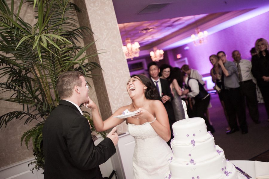 Cake cutting during a wedding reception at the Neshanic Valley Golf Course in Neshanic Station, NJ. Captured by northern NJ wedding photographer Ben Lau.