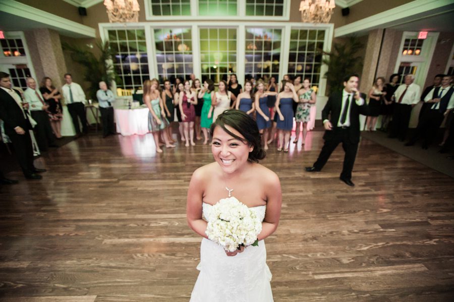 Flower toss during a wedding reception at the Neshanic Valley Golf Course in Neshanic Station, NJ. Captured by northern NJ wedding photographer Ben Lau.