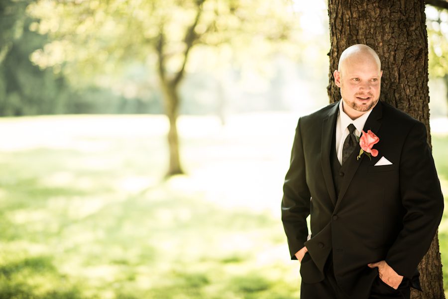 Groom poses by a tree during portraits on his wedding day at Perona Farms in Andover, NJ. Captured by northern NJ wedding photographer Ben Lau.