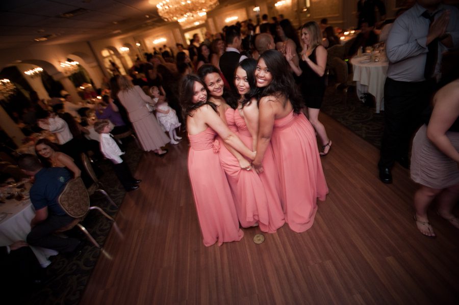 Bridesmaids pose for a photo during a wedding reception at Perona Farms in Andover, NJ. Captured by northern NJ wedding photographer Ben Lau.