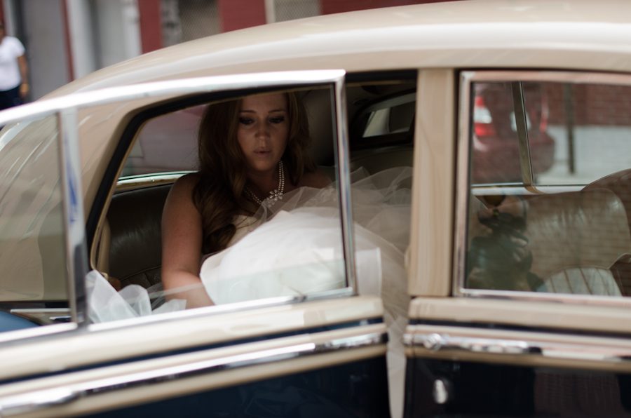Bride exits the limo to St. Alphonsus Church in Baltimore, MD. Captured by Ben Lau Photography.