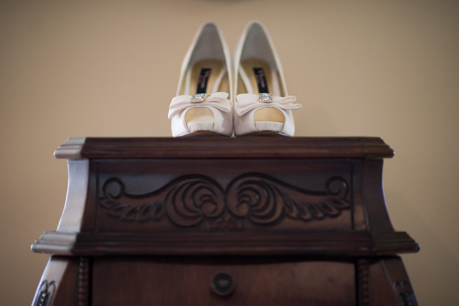 Bride's shoes on the morning of their wedding day at the Belvedere Hotel in Baltimore, MD. Captured by Ben Lau Photography.