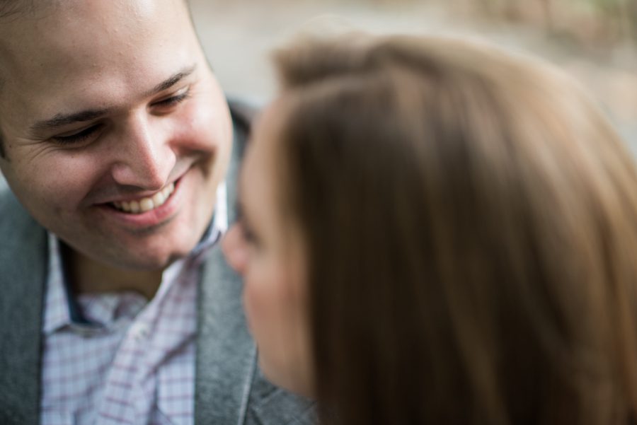 Katie and Craig smile at each other during their engagement session in Central Park with NYC wedding photographer Ben Lau.