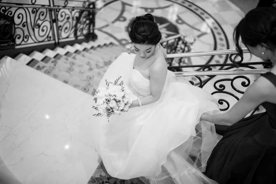 Bride descends the stairs at The Grove in Cedar Grove, NJ. Captured by northern NJ wedding photographer Ben Lau.