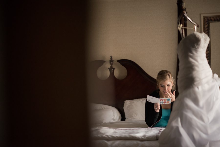 Bride reads a note from her fiance on the morning of her wedding at the Madison Hotel in Morristown, NJ. Captured by NJ wedding photographer Ben Lau.