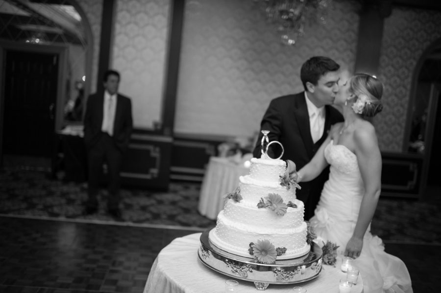 Cake cutting during Alexis and Mike's wedding reception at the Madison Hotel in Morristown, NJ. Captured by NJ wedding photographer Ben Lau.