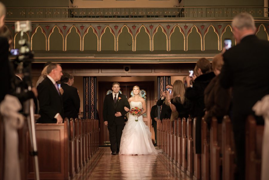 Bride walks down the aisle during her wedding ceremony at the Church of Assumption in Morristown, NJ. Captured by NJ wedding photographer Ben Lau.
