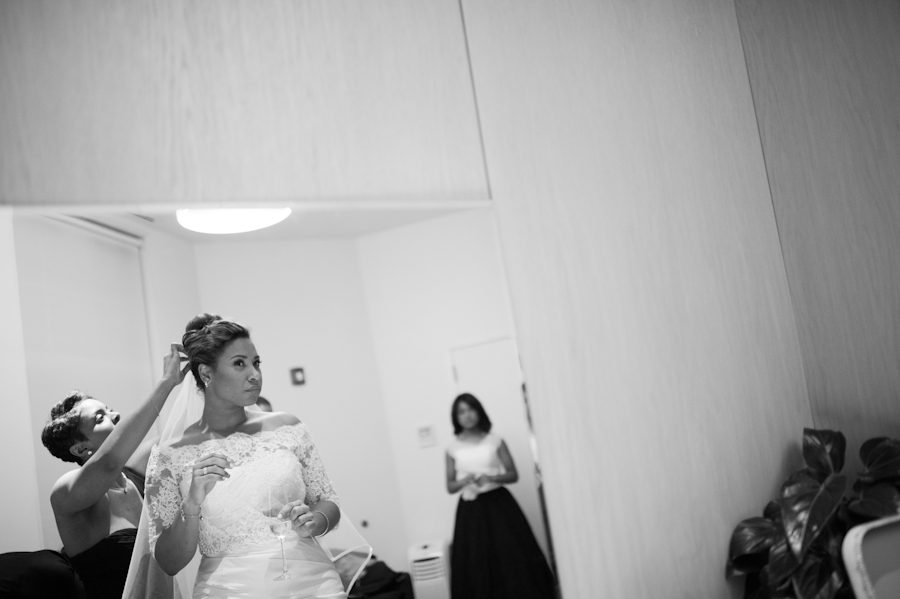 Bride fixes her hair on her wedding day at the Maritime Parc in Jersey City, NJ. Captured by NJ wedding photographer Ben Lau.